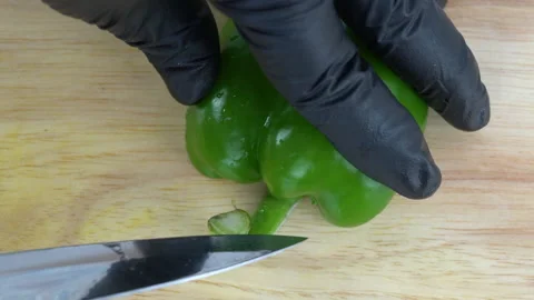 Close up Top-view Speed chopping green bell pepper in a half from the core Stock-Footage 136806733
