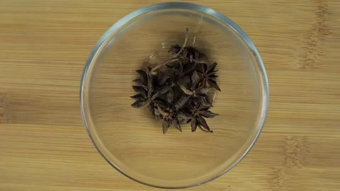 Close up top view star anise poured into a bowl Stock Footage 264889047