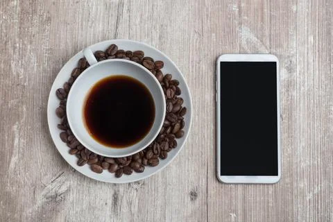 Close-up of top view of table with cell phone and coffe cup Foto stock