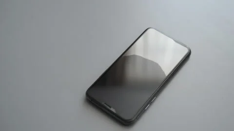 Close-up top view of technician finger applying pressure to new glass screen of Stock Footage 297633318