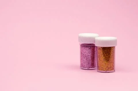 A close-up top view of tiny colorful sequins in round containers, elegantly.. Stock Photos