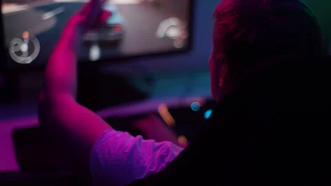 Close-up top view of unrecognizable male gamer driving race video game on Stock Footage 250260480