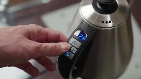 Close-up top view of unrecognizable man setting temperature and timer on Stock Footage 306701027