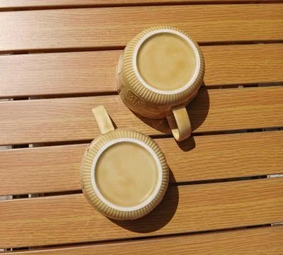 Close-up top view of upside-down ceramic cups with pattern reflections Stock Photos