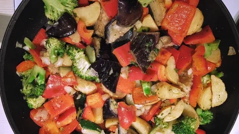 Close-up top view on vegetable mix frying in a pan Stock Footage 104345807