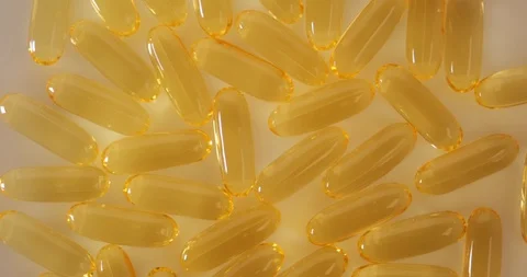 Close up top view: Vitamins supplements pills omega 3. Fish oil capsules. 4k Stockbeeldmateriaal 108100566