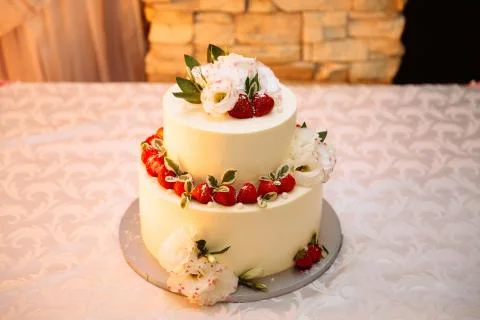 Close-up top view of a wedding three-story cream cake. Confectionery asteroids Stock Photos