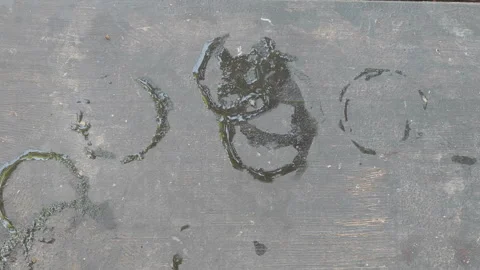 Close up top view of wet coaster marks, condensation rings, and water stains Stock Footage 345878707