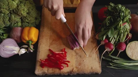 Close up of a top view of a woman's hands cutting an onion into small julienn Stock Footage 145242248