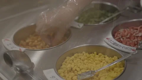 Close up toppings being put in noodle cup ramen Stock Footage 228755646