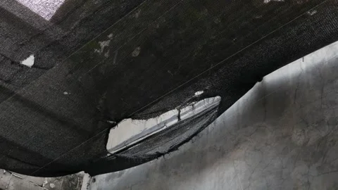 Close-Up of Torn Black Shade Cloth Roof Covering Outdoors Stock Footage 336983352