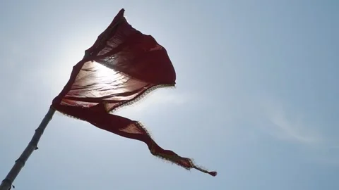 Close-up of a torn flag on an aghori tent flapping against the sun Stockbeeldmateriaal 284632458