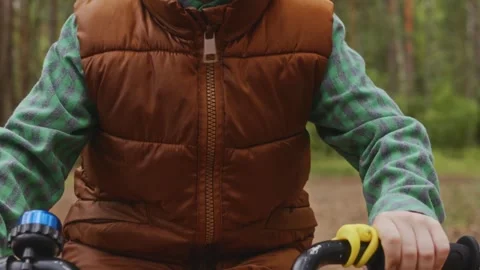 Close torso view boy cycling forest independence Stock Footage 317554350