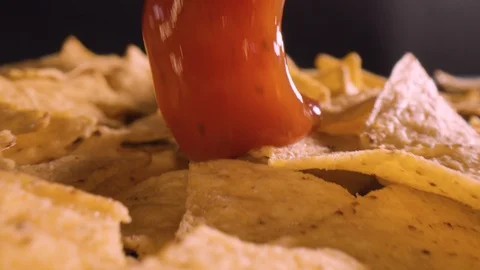 Close-up of tortilla chips with red salsa sauce Stock Footage 128943890
