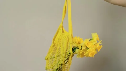 Close-up of tote bag with flowers inside, florist holding bouquet, perfect for f Stock Footage 273864834