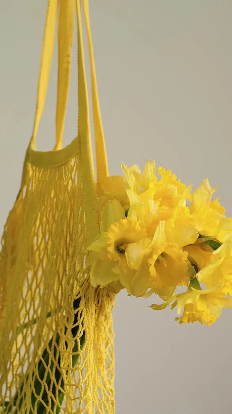 Close-up of tote bag with flowers inside, florist holding bouquet, perfect for f Stock Footage 273864848