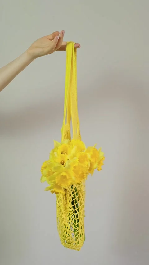 Close-up of tote bag with flowers inside, florist holding bouquet, perfect for f Stock Footage 273864867