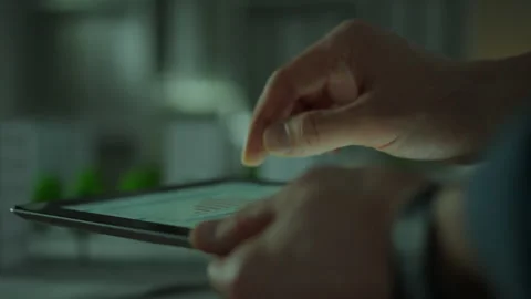 Close-up of a touch tablet. Hands of a Caucasian man control data informatio Stock Footage 281417824