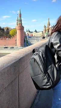Close up of a tourist backpack on a bridge with old towers in the background 스톡 사진