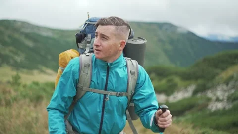 Close-up of a tourist with a backpack going on a hike in the mountains. Stock Footage 221607561