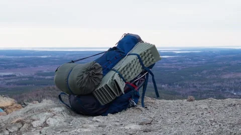 A close-up of a tourist backpack lying on top of a mountain. Stock Footage 270024220