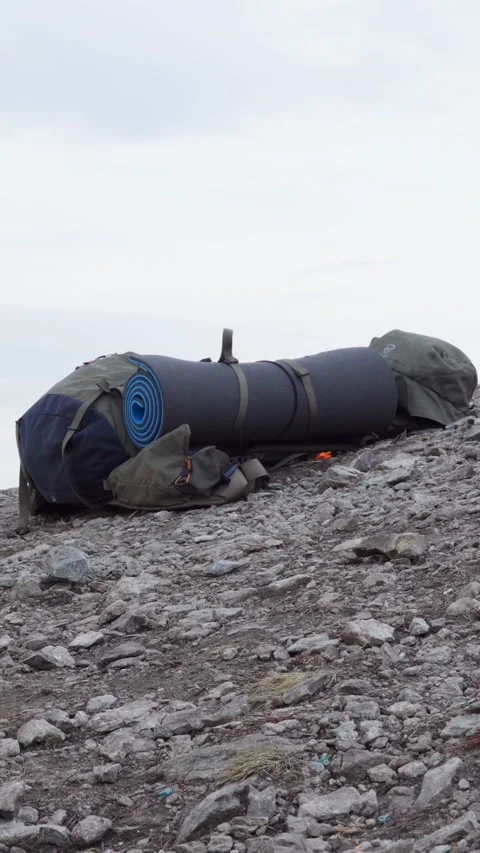 A close-up of a tourist backpack lying on top of a mountain. Stock Footage 270268695