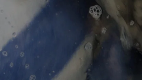 Close up of towels spinning inside washing machine in slow motion Stock Footage 117626278