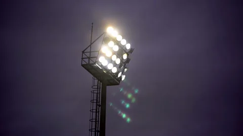 Close up tower lighting the Stadium of Light in a cloudy twilight sky purple Stock Footage 147630302