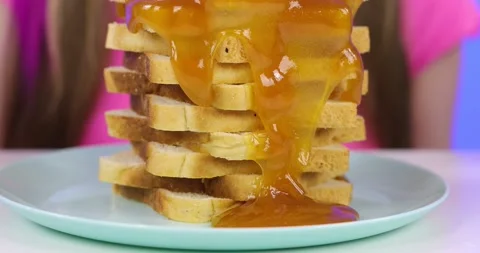 Close-up of a tower of toast with honey Stock Footage 166901716