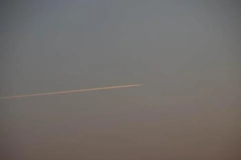 Close up of a trace of airplane during sunset Stock Photos