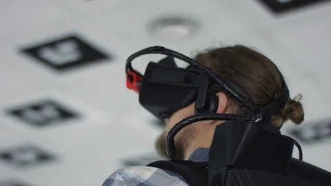 Close up tracking arc 360 degree shot of a young man wearing virtual reality Stock Footage 123090565