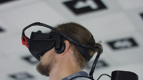 Close up tracking arc 360 degree shot of a young man wearing virtual reality Stock Footage 123318865