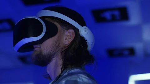 Close up tracking arc 360 degree shot of a young man in virtual reality headset Stock Footage 127857954