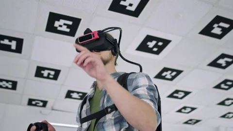 Close up tracking arc 360 degree shot of a young man wearing virtual reality Stock Footage 132337349
