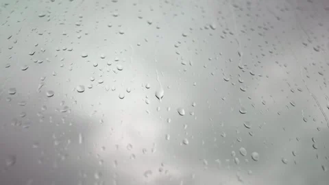 Close up Tracking motion of raindrop on the apartment Window with Overcast sky Video stock 339286066