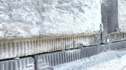 Close-Up Tracking Shot Along a Textured Concrete Block Wall Stock Footage 341178186