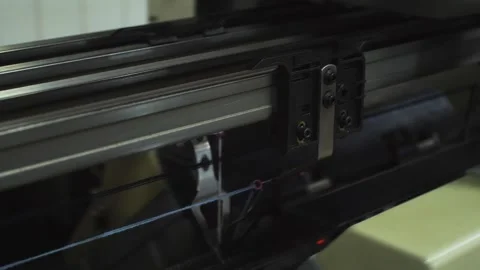 Close-up tracking shot of automatic weaving machine producing fabric in texti Stock Footage 279879176