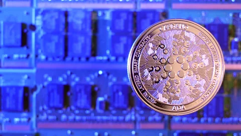 A close tracking shot of Cardano ADA crypto currency coin hovering over a Stock Footage 160949239