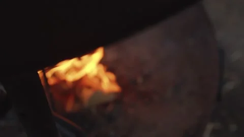 Close up tracking shot of fire burning in outdoor fireplace in wintery setting Stock Footage 146266822