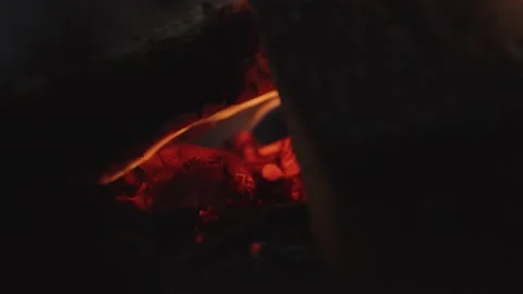 Close up tracking shot of fire burning in outdoor fireplace in wintery setting Stock Footage 146267077