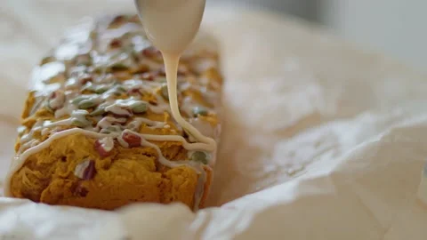 Close up tracking shot of icing on baking recipe, pumpkin loaf 库存影片 219405508