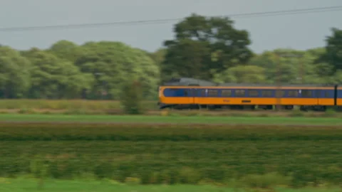 Close Up Tracking Shot of an InterCity Passenger Train Passing Through Dutch Stock Footage 345635647
