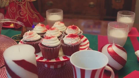 Close-up tracking shot over cupcakes and red punch at a Christmas party. Stock Footage 127069025