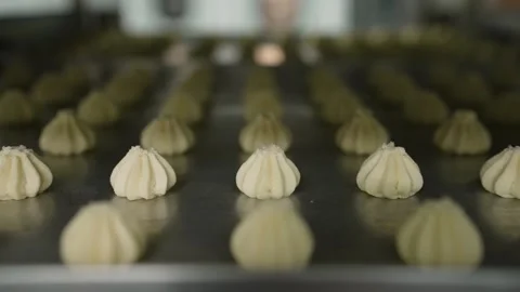 Close up tracking shot of piped cookie dough on a baking sheet before baking in Stock Footage 346729060