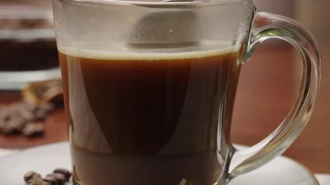 Close-up tracking shot of a spoon stirring a cup of coffee Stock Footage 237563373