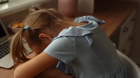 Close-up tracking shot of tired exhausted little child girl sleeping on table Stock Footage 167238612