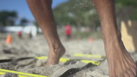 Close-up, tracking, unrecognizable man with an agility ladder on a beach, Brazil Vídeo Stock 140542860