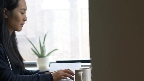 Close up tracking of woman typing on computer Stock Footage 128463966