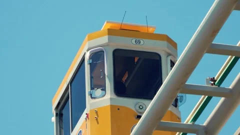 Close up tracking of yellow Sky Capsule retro car cabin moving against blue sky Stock Footage 336664614
