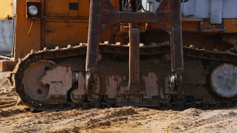 A close-up of the tracks of an old tractor at a construction site. Video stock 159422973